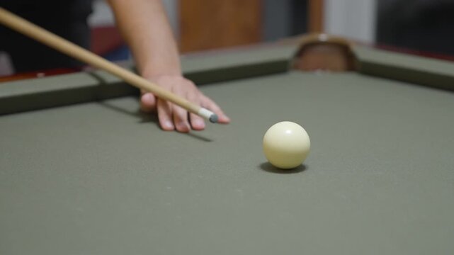 Close-up of a Man Playing Billiards and Pocketing a Ball