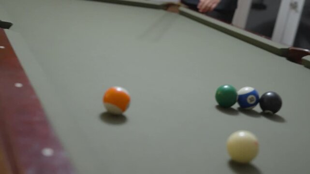 Close-up of a Man Playing Billiards and Pocketing a Ball