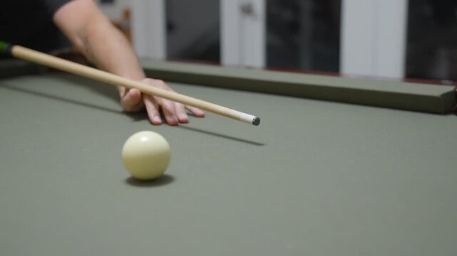 Close-up of a Man Playing Billiards and Pocketing a Ball