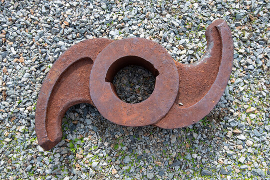 Rusty piece of metal on gravel ground