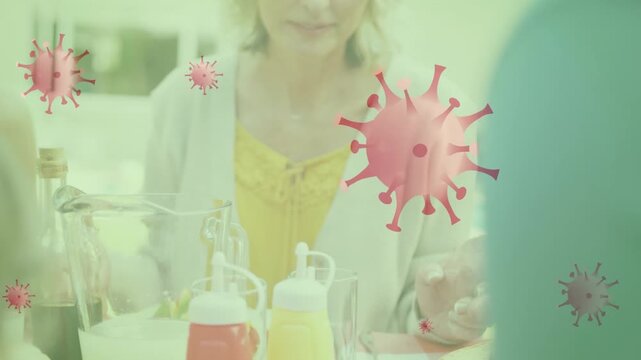 Animation of virus cells over caucasian family praying at table