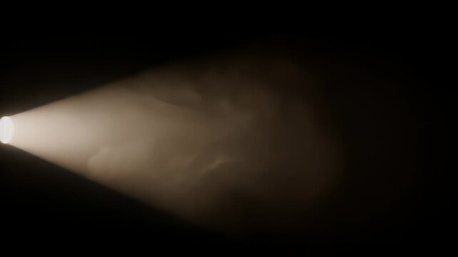 Golden light beam breaking through darkness on black background