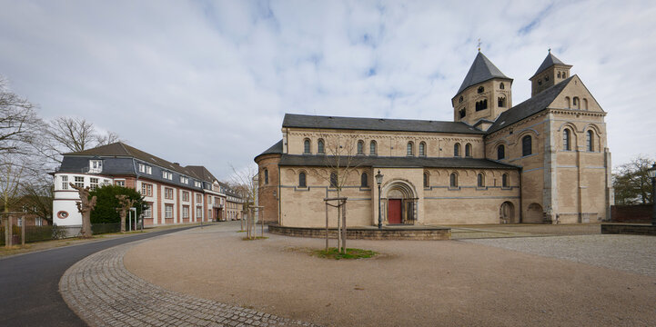 Scenic wide-angle view of the Romanesque Knechtsteden Abbey with its historic courtyard and monastery buildings in Dormagen, Germany