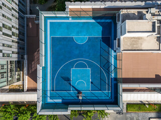 Basketball courts in modern city on rooftop © Minase