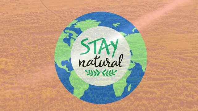Animation of stay natural text in white over globe against aerial view of fields