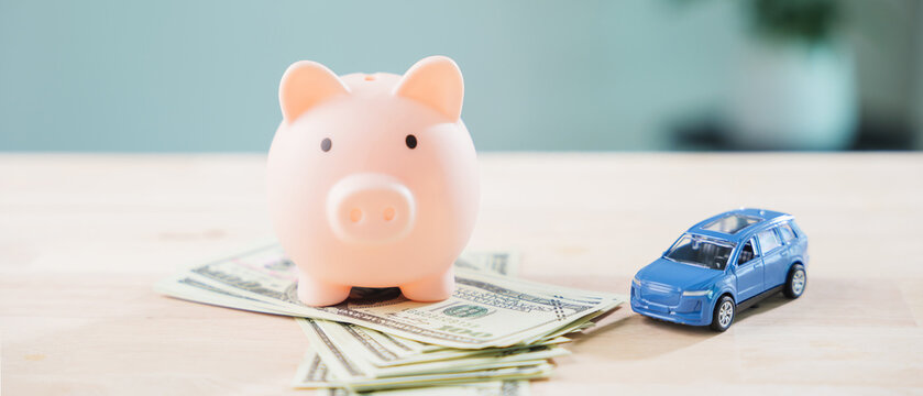 Pink piggy bank to save money for auto car fuel and refinance loan, finance gas transportation cost while managing personal budget for monthly vehicle insurance and drive cost