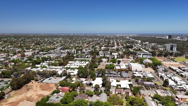 Parkside, Adelaide, South Australia: 4K aerial drone footage of residential suburbs with tree-lined streets, roundabouts, purple jacaranda flowers, houses and urban landscape