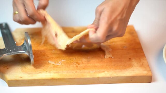 Woman Hands Tenderizing Thin Chicken Fillet with Meat Mallet on Cutting Board