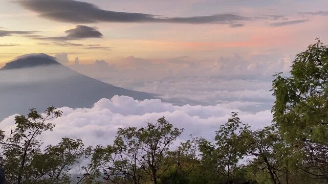 "Majestic Mountain Peak Above the Sea of Clouds During Golden Sunrise"