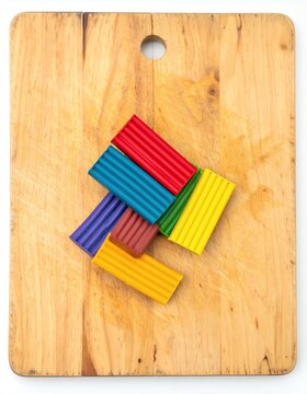 Colorful Polymer Clay Blocks on a Wooden Cutting Board.