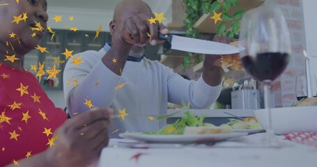 Carving man light sweater slicing roast with knife at home table, partner red top holding fork © vectorfusionart