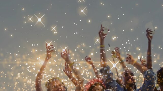 Event crowd raising cups and phones, responding to off-screen music, gold bokeh drifting over hands