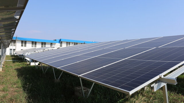Solar power equipment. Solar panels on a metal frame on a farm produce clean energy from renewable energy in side view with copy space with selective focus.