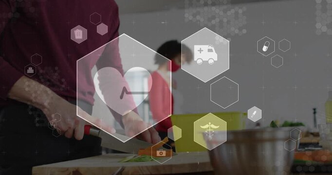 Male cook chopping carrots, camera moving close-up and animating health UI heart icon for safety