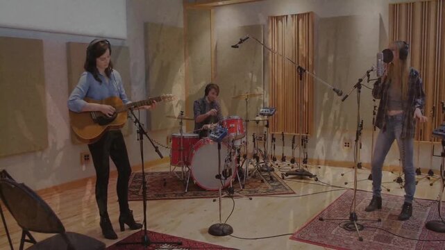 Recording starting with guitarist strumming, drummer keeping tempo, singer singing, overlaying trio