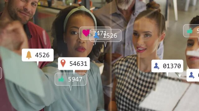 Team leader placing note on glass, guiding marketing team, causing likes and hearts multiplying