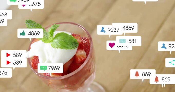 Notifications popping left clustering over glass with berry dispersing right showing food marketing