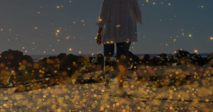 Vertical video: Senior woman walking shore, low shot prosthetic, health bokeh leaving her visible
