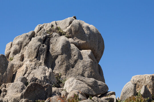 Granite rock formation under blue sky on the coast of Punta de Tralca, Chile