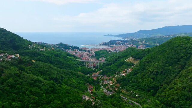 Establishing drone shot of Rapallo cityscape, highway bridge and mediterranean sea