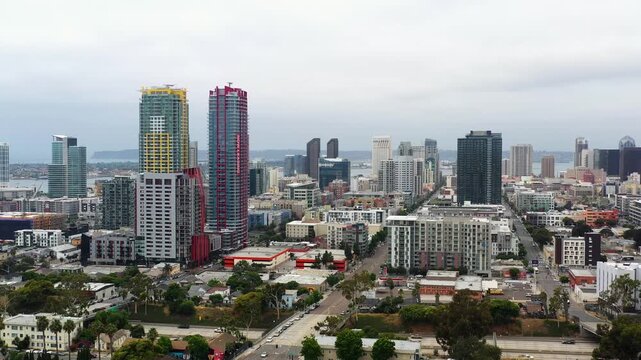 Drone moving forward toward downtown San Diego capturing city streets and buildings in early morning.