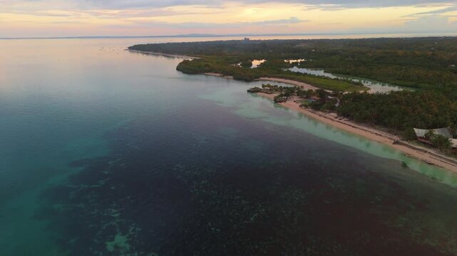 aerial view of the peaceful Santa Fe beach on Bantayan Island, Philippines. Crystal clear waters and lush tropical vegetation during golden hour
