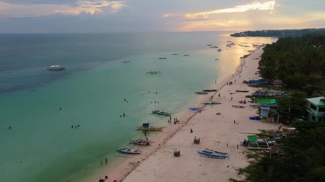 Panoramic aerial drone sunset view of coastline on Bantayan Island, Philippines. Showcasing clear blue waters, coral reefs, and the peaceful tropical island atmosphere