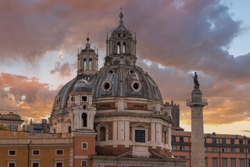 Obraz premium Roman Church of Saint Mary of Loreto and Tryan's column with the figure of Saint Peter on top under a cloudy sky