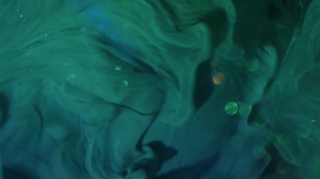 Vertical video. Dye spill. Blur paint wave. Sparkling green blue acrylic liquid pouring on art sphere. Color water shimmering mix abstract background.