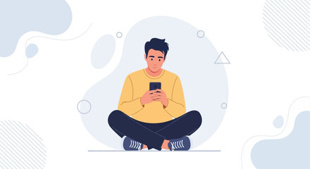 Obraz premium Young man sitting cross-legged, looking at smartphone, modern abstract background