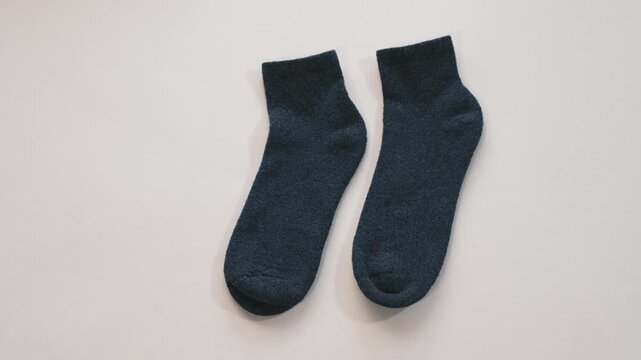 Pair of dark socks on white background clean minimal style emphasizing simple composition and versatile commercial use