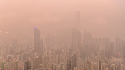 Fototapeta premium March 27 2026 HONG KONG, CHINA Warm hazy skyline rising over Kowloon
