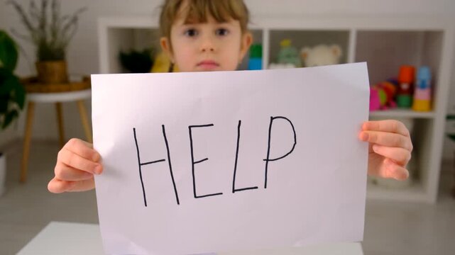 The child is doing homework at home, please help. Selective focus. kid.