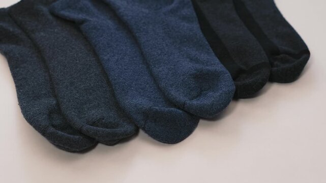 Multiple pairs of socks on white background studio composition emphasizing variety and suitable for commercial visuals