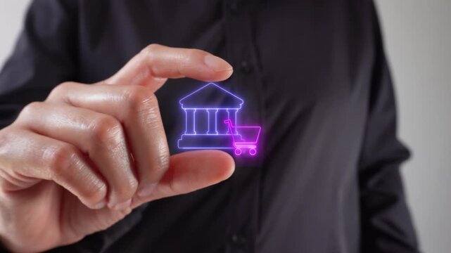 Bank financing for purchases. Close-up of a woman's hands holding a virtual bank icon with a shopping cart between her two fingers.
