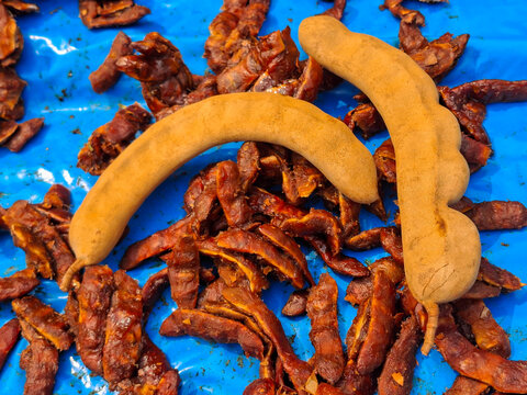 Tamarind, a tropical fruit with a sweet and sour taste, is used as an ingredient in cooking.
