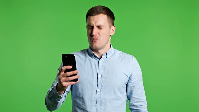 Angry Man Reacting to Bad News on Smartphone over Green Screen