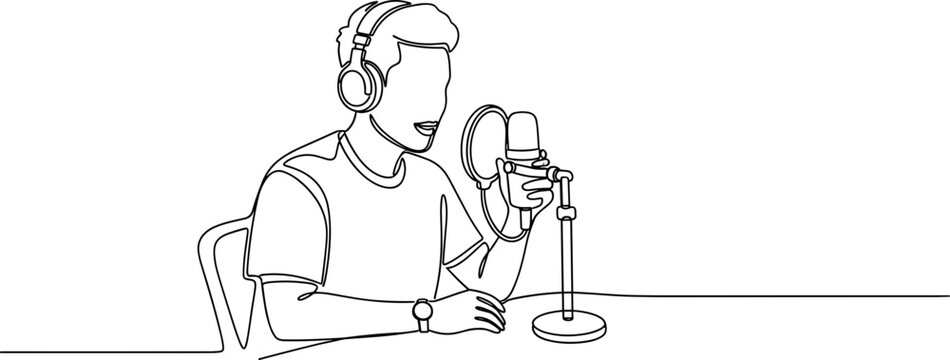 Man wearing headphones speaking into microphone.