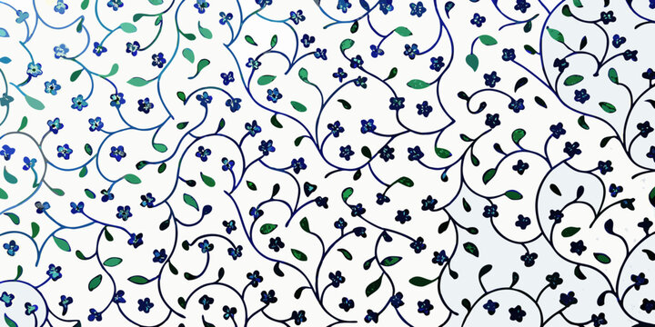 Intricate floral pattern with blue blossoms and green foliage on white
