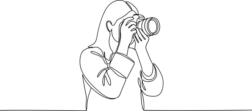 Woman holding a camera to her eye.