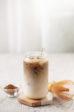 Iced hojicha tea latte in a tall glass. Japanese green roasted tea. Perfect for a summer day.