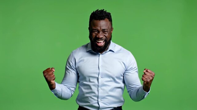 Happy man celebrating success with arms raised and joyful expression