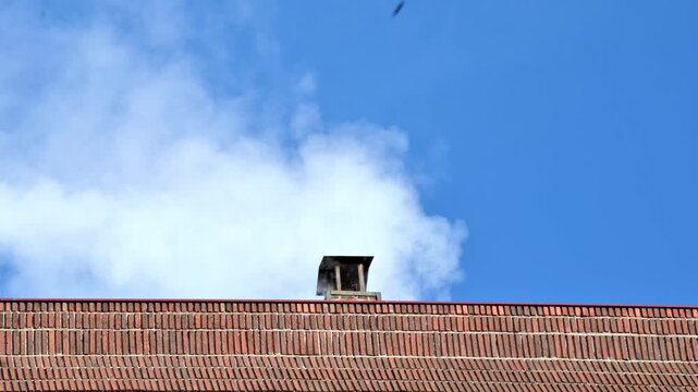 Brick Roof Chimney Smoke Rising Over Red Brick Wall Under Blue Sky, Urban Scene