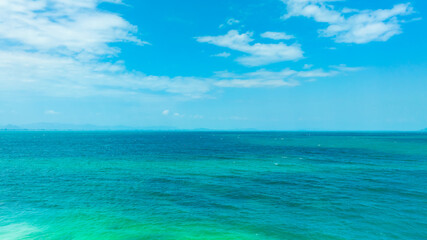Fototapeta premium Tropical Nature clear sky and summer sea water under a clear blue sky with beautiful clouds and bright sunlight. Perfect for summer vacation and travel background 