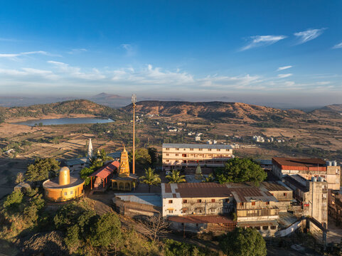 A serene morning view of Trimbakeshwar in Maharashtra, India, featuring soft light over the surrounding hills and sacred landscape.