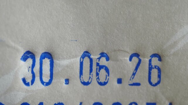 Date stamp expiration date 30 06 26 imprinted on white paper packaging material.