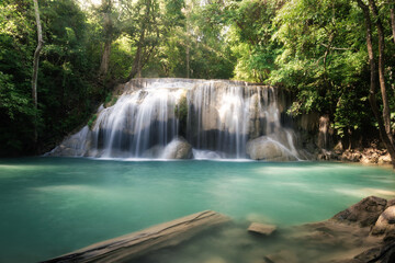 Fototapeta premium Erawan Waterfall Tier 2 at Wang Macha is a stunning natural attraction in Kanchanaburi Province, Thailand, refreshing and visually striking landscape. Surrounded by lush green forest and tropical foli