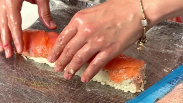 Making sushi rolls step by step in a kitchen