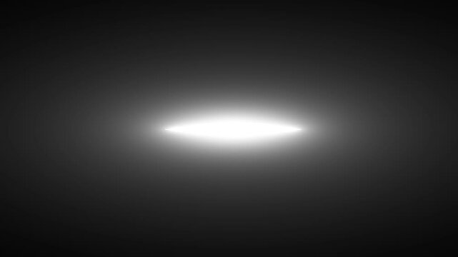 A bright elliptical light source dominates a dark nearly black background creating high contrast high quality