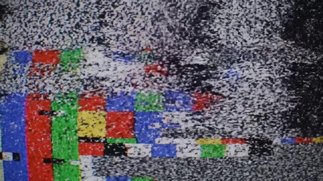Abstract static interference pattern with colorful bars on a retro television screen